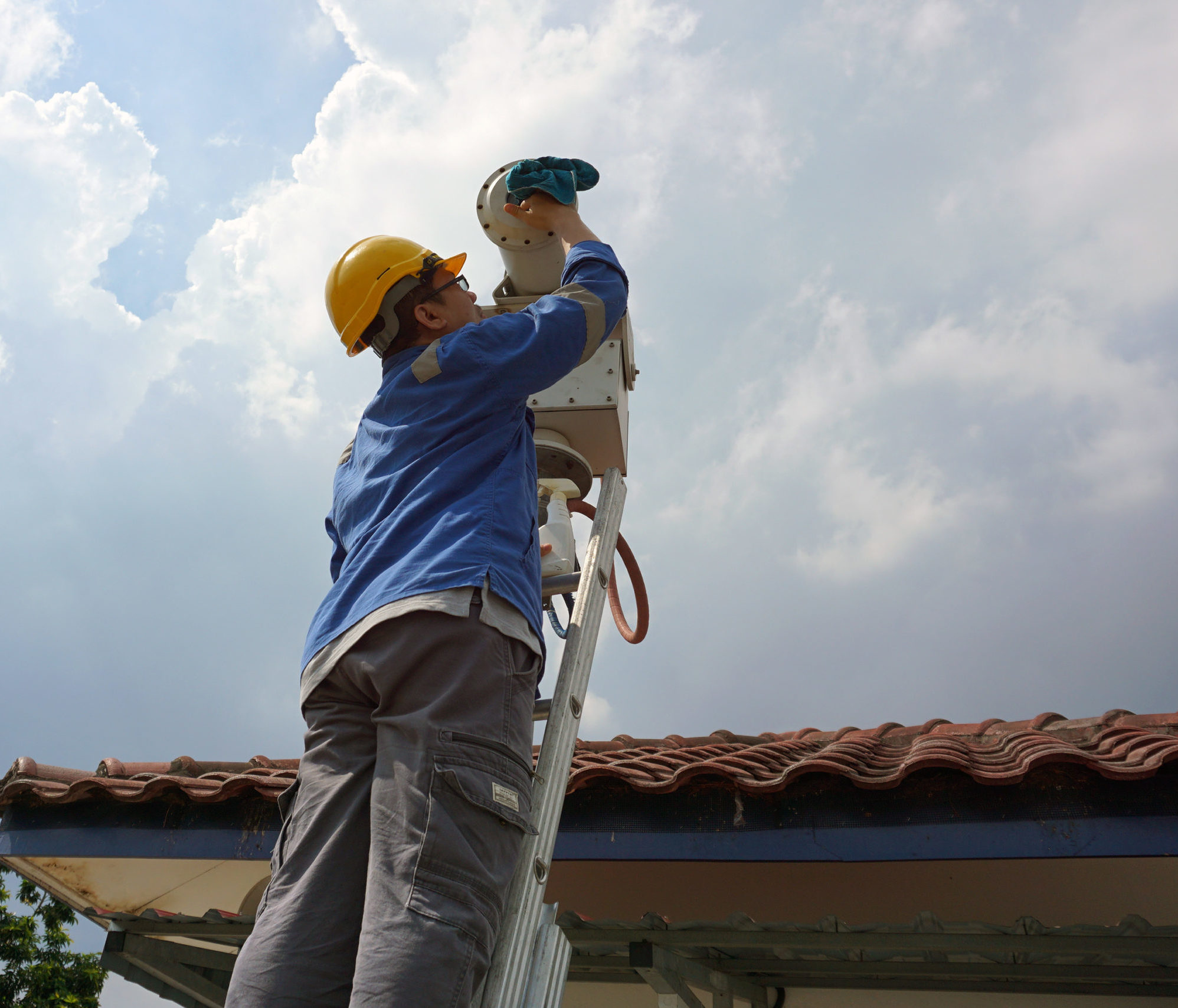 A male worker doing a maintenance work by cleaning